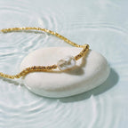 Helena George. Gold bracelet with a pearl on a white stone